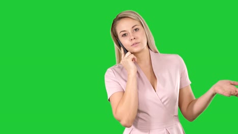 Beautiful-girl-blonde,-speaking-with-someone-on-phone-on-a-Green-Screen,-Chroma-Key