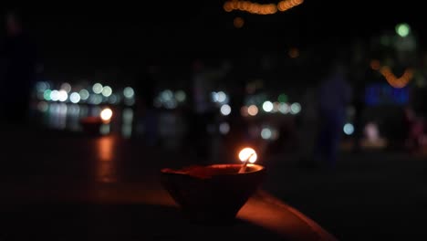 Traditional-Indian-earthen-oil-lamp-with-cotton-wick-burning-at-Pushkar-Lake