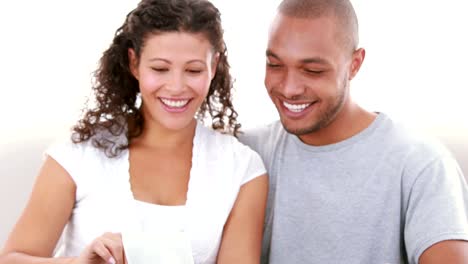 Relaxed-couple-on-the-sofa-looking-at-the-ultrasound