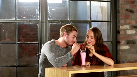 Cute-couple-sipping-a-fresh-drink-together