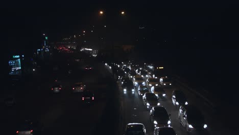 Time-lapse-shot-of-traffic-on-road-in-a-city-at-night,-Delhi,-India