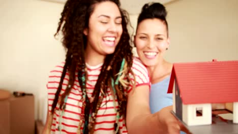 Smiling-lesbian-couple-unpacking-cardboard-box