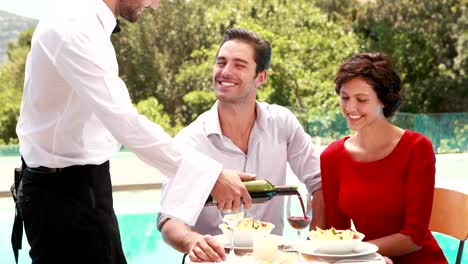 Waiter-pouring-red-wine-in-glass