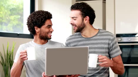 Happy-homosexual-couple-using-computer