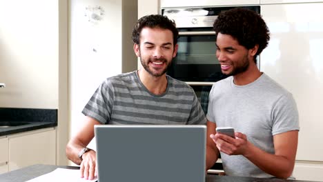 Happy-homosexual-couple-using-computer