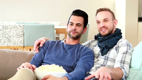 Homosexual-couple-men-eating-popcorn-together