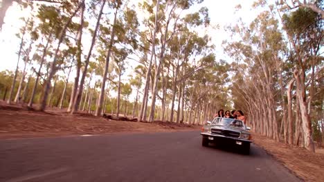 Teenager-friends-embracing-joyfully-on-their-road-trip-at-sunset