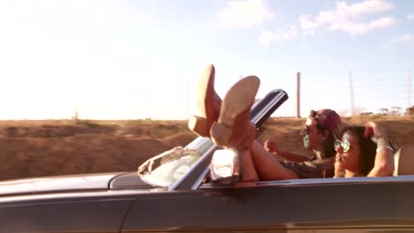 Adventurous-teenage-couple-on-a-road-trip-with-convertible