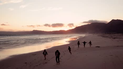 Teen-friends-enjoying-a-walk-at-beach-on-sunset