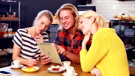 Smiling-friends-looking-at-tablet