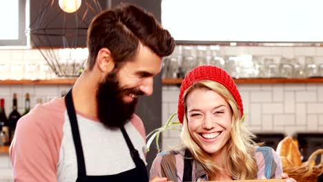 Hipster-couple-holding-open-sign