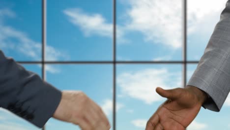 Businessmen-shake-hands-in-office.