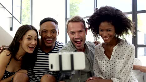 Multi-ethnic-friends-smiling-and-taking-selfie