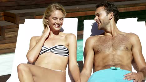 Attractive-couple-relaxing-by-the-pool