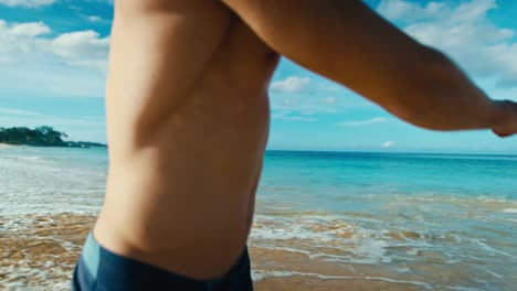 Couple-holding-hands-walking-down-tropical-beach-in-slow-motion