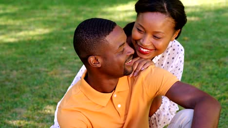 Cute-couple-sitting-on-the-grass