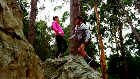 Couple-jumping-on-a-rock