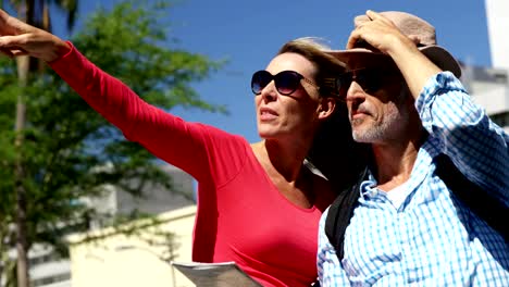 Mature-couple-is-looking-a-map-and-pointing