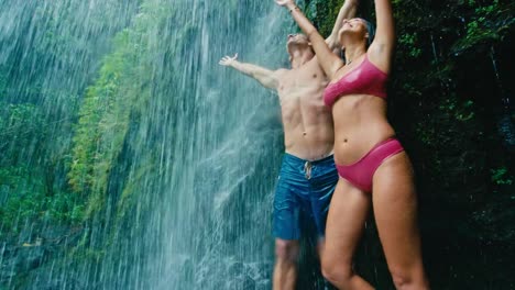 Couple-Relaxing-Under-Waterfall