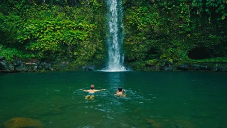 Couple-Swimming-to-Waterfall