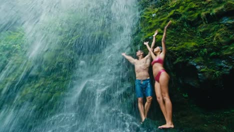 Couple-Relaxing-Under-Waterfall