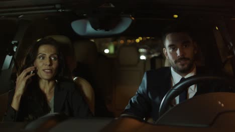 Attractive-Businessman-and-Woman-Talking-in-a-Car-at-Evening