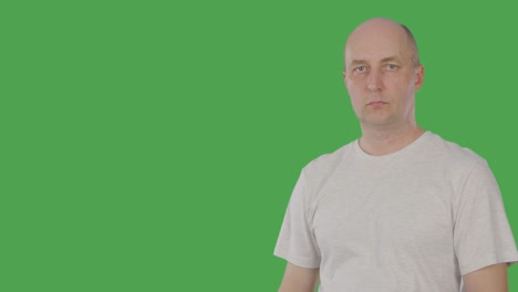 Caucasian-man-pointing-forefinger-for-showing-or-presenting-something-isolated-on-green-background.-1-2-3-point.-Alpha-channel,-keyed-green-screen