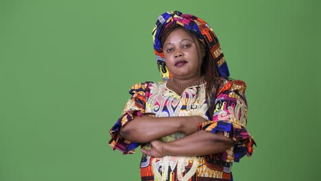 Overweight-beautiful-African-woman-wearing-traditional-clothing-against-green-background