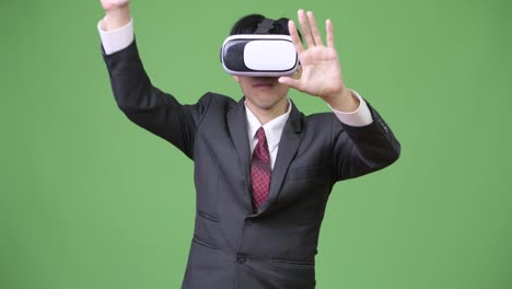 Young-Asian-businessman-using-virtual-reality-headset