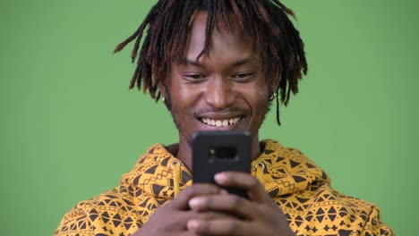 Young-happy-African-man-using-phone