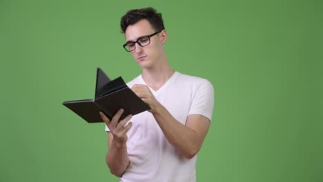 Young-handsome-nerd-man-reading-book