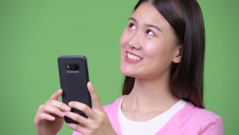 Young-beautiful-Asian-woman-using-phone