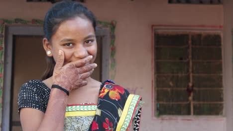 Mid-shot-of-a-young-beautiful-pretty-Indian-woman-laughing-and-smiling-with-happiness-and-joy-and-looking-at-someone-at-the-peaceful-location-and-safety-of-her-home-static-shot