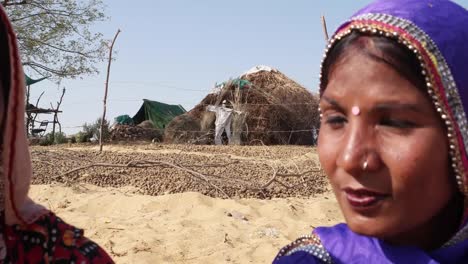 Pan-close-from-one-friend-two-another,-wearing-traditional-costumes-in-a-desert