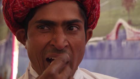 Portrait-of-a-Rajasthani-young-male-in-red-turban-in-Pushkar,-India