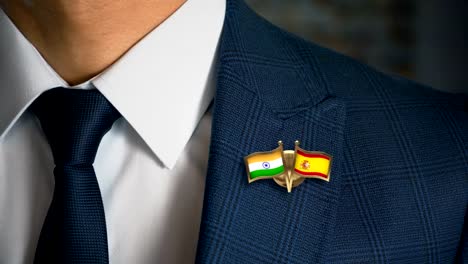 Businessman-Walking-Towards-Camera-With-Friend-Country-Flags-Pin-India---Spain