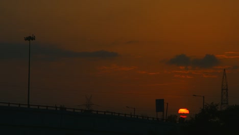 Locked-on-shot-of-an-overpass-bridge-at-sunset,-Delhi,-India