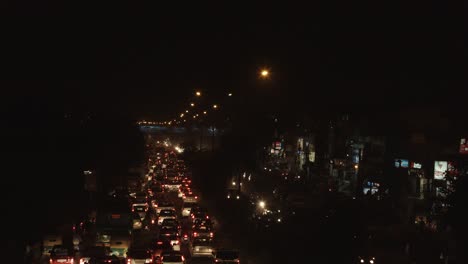 Time-lapse-shot-of-traffic-on-road-in-a-city-at-night,-Delhi,-India