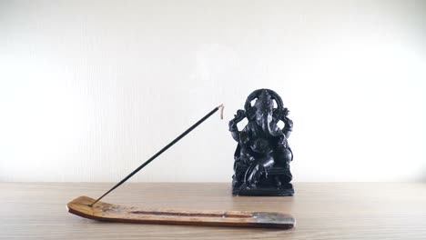 Burning-incense-stick-on-a-background-Ganesh-statues-in-the-Buddhist-temple