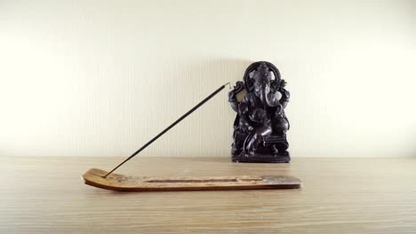 Burning-incense-stick-on-a-background-Ganesh-statues