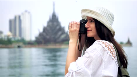 Tourist-woman-taking-photo-picture-of-the-asian-temple