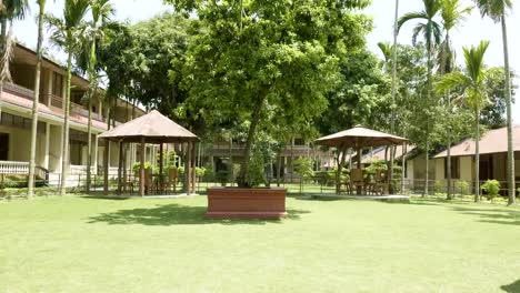 Green-courtyard-of-the-hotel-in-asia.-Village-in-Chitwan-national-park,-Nepal.