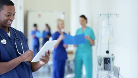 Portrait-of-African-American-doctor-working-on-technology