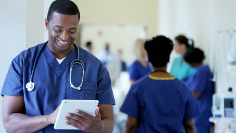 Portrait-of-African-American-male-nurse-using-technology