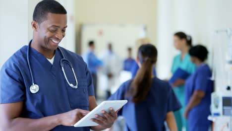 Portrait-of-African-American-male-staff-using-technology