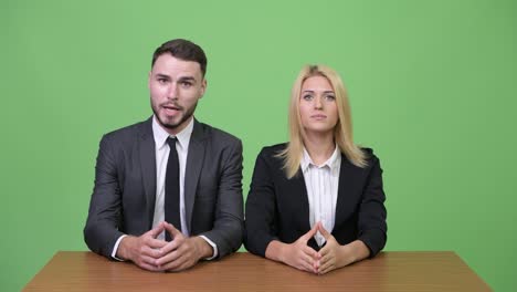 Young-businessman-flirting-with-young-businesswoman-while-working