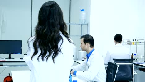 Asian-female-scientists-or-chemists-looking-to-camera-with-attractive-smile.-Team-Scientists-working-in-a-laboratory-together.-4K-Resolution.