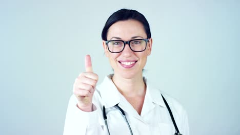 Portrait-of-a-female-doctor-with-white-coat-and-stethoscope-smiling-looking-into-camera-on-white-background.