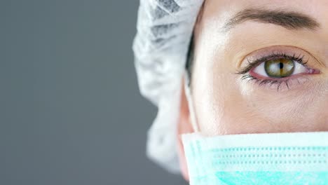 Portrait-of-a-female-doctor-with-white-coat-and-stethoscope-smiling-looking-into-camera-on-white-background.