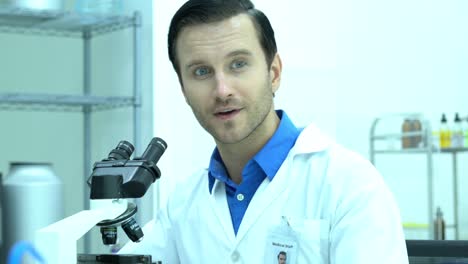 Portraits-of-scientist-male-is-looking-through-microscope-and-working-in-modern-laboratory-or-medical-center.-Concept-of-science,-testing-development-and-lab-industry.